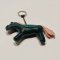 Green horse keychain with a pink tail