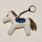 White horse keychain with a light blue tail