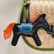 Dark brown horse keychain with an orange tail