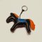 Dark brown horse keychain with an orange tail