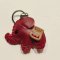 Red baby elephant keychain with a brown saddle