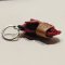 Red baby elephant keychain with a brown saddle