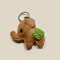 Brown baby elephant keychain with a green saddle