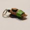 Brown baby elephant keychain with a green saddle