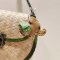 Brown baby elephant keychain with a green saddle