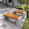 ม้านั่งสนามบล็อคสีไม้สัก CONC Concreation ขนาด 120 ซม. ที่นั่งไฟเบอร์ซีเมนต์ CONWOOD ฐานปูน Two-Tone สีเทาสองโทน จัดวางบนทางเดินในสวน