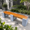 ม้านั่งสนามยาวบล็อคเดี่ยว CONC Concreation ขนาด 180x50x40 ซม. ที่นั่งระแนงสีไม้สัก ฐานปูนซีเมนต์สีเทา 3 จุด เสริมโครงเหล็ก จัดวางในสวนโมเดิร์น